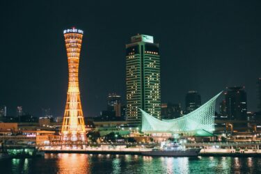 lighted high rise building near body of water during night time